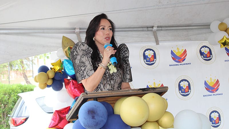 Honorary Consul Jenny Lynn Ho-Vijungco delivers remarks at the inauguration of the Philippine Honorary Consulate in Chandler, Arizona. She speaks at the podium decorated with balloons and a backdrop featuring the Philippine seal.